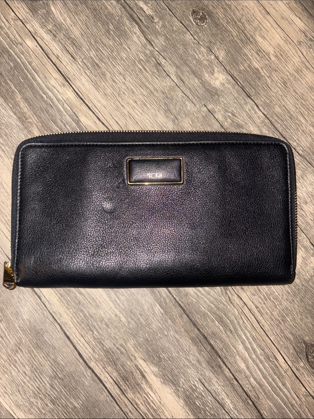Black TUMI leather zip wallet